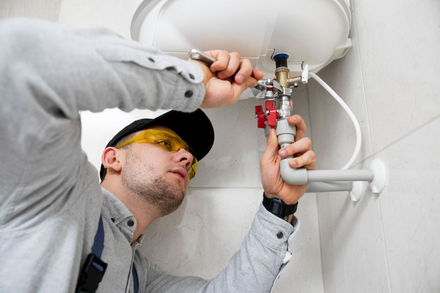 Engineer fitting a valve on a heating system